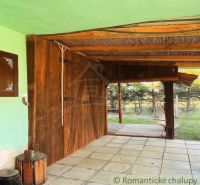A covered terrace at a family house in Nové Hony with garden furniture and paving.