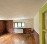 A room with brick cladding and a wooden decor floor in a family house.