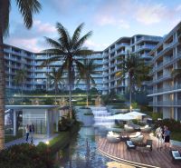 Apartment construction in Phuket with a terrace, palm trees, and an illuminated complex.