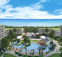 A view of apartment construction in Phuket by the beautiful coastline with palm trees.