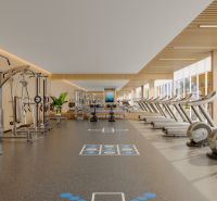 A fitness center with machines and treadmills in the apartment complex Výstavba bytov.