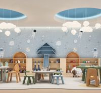 Interior of a children's playroom with a space theme and a wooden decor floor.