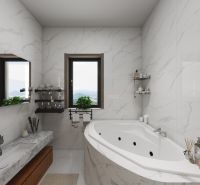 A bathroom in a family house with marble tiles, a bathtub, and windows with a view.