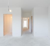 Interior of a family house with white walls and unfinished door openings.