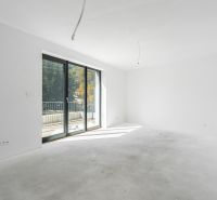 A spacious room with glass doors in a family house, view of the terrace.