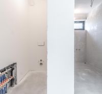 Empty space with white walls and installations in the Family House.