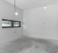 Empty room in a family house with a concrete floor and wall installation.