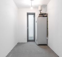 Technical room with a boiler and white walls in a family house.