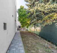 Exterior of a family house on Kľukatá Street in Bratislava - Prievoz with a sidewalk and trees.