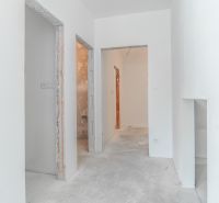 A family house with white walls and visible raw construction elements, floor ready for finishing.
