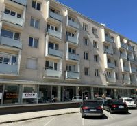A building on Hviezdoslavova Street in the city of Zvolen with balconies, a shop on the ground floor.