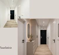 A hallway in a 3-room apartment with white walls and a wooden decor floor.