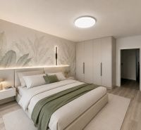 Bedroom in a 3-room apartment with a wooden decor floor and a large bed.