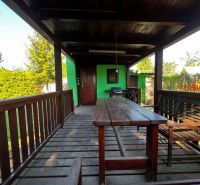 In Lozorno on Záhrady Street, there is a spacious terrace with wood near the cottage.