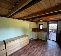 Interior with cabinets, kitchen unit, and floor with wood decor. Gardens.