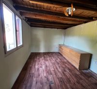 Interior of a room with a drawer chest and a wooden decor floor in Gardens.