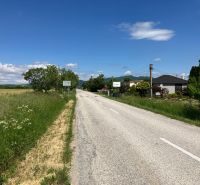 Road in the village of Krtovce, suitable for plots - housing, with green plots on the sides.