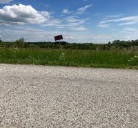 A dirt road and greenery in Krtovce ideal for residential plots.