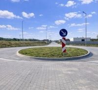 Roundabout on the properties - housing in Dvory nad Žitavou with a traffic sign.