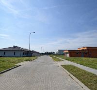 Street in Dvory nad Žitavou, Plots - residential, with unfinished houses and sidewalks.