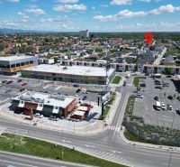 Shopping center, parking lot, and family houses in Bratislava - Podunajské Biskupice.