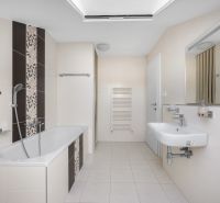 Bathroom with shower and bathtub in a family house, tiles, light-colored tiles, mirror.