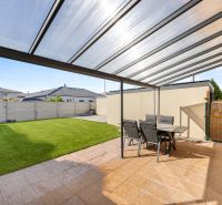 Covered terrace with seating and lawn in a family house in Bratislava - Podunajské Biskupice.