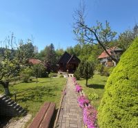 A cottage on Bukovská Road in Čadca surrounded by a beautiful garden and trees.