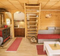 Wooden cabin with a warm interior, fireplace, and wooden decor flooring.