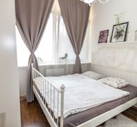 Bright bedroom with bed and decorations, 2-room apartment, wooden decor flooring.
