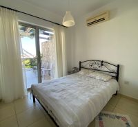 Bedroom in a 2-room apartment with a bed, air conditioning, and access to the terrace.