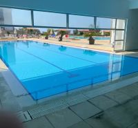 Indoor pool with a view of the exterior area and terrace at a 2-bedroom apartment in Tatlisu.