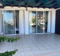 Entrance terrace in a 2-bedroom apartment in Tatlisu with sliding glass doors.