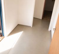 A hallway with simple white walls and a light floor in a 3-room apartment.