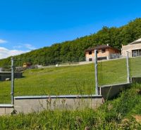 Residential plots in Horná Ves with fencing and views of the surrounding forests.
