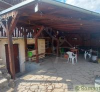 Covered terrace at the cottage in Holíč with seating and rock paving.