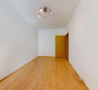 A room with a wooden floor decor in a 4-room apartment, white walls, and a light fixture.