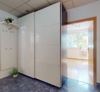 Entrance hall with a wardrobe in a 4-room apartment with a ceramic tile floor.