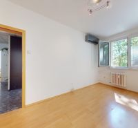 A room with a wooden floor decor, air conditioning, and a window in a 4-room apartment.