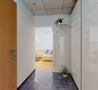 Hallway with wooden doors, white walls, and a pleasant floor with a wooden decor.