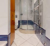 Bathroom with a shower, tiles, and storage space in a 4-room apartment.