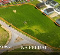 Residential plots in Lehnice, surrounded by roads and neighboring houses.