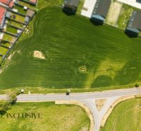 Aerial view of residential plots in Lehnice with green areas and roads.