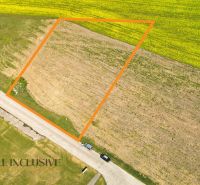 Plots - housing in Mliečany in Dunajská Streda, including a section of road and topsoil.