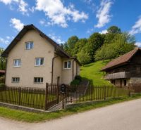 A family house on Budatínska Lehota Street in Kysucké Nové Mesto, next to a wooden house.