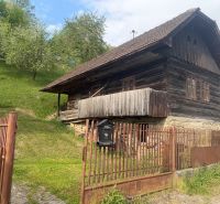 A family house in Budatínska Lehota, Kysucké Nové Mesto with a wooden cottage and green trees.