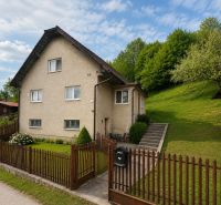 A family house in Budatínska Lehota in Kysucké Nové Mesto surrounded by greenery and a fence.