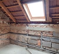 Attic floor plan with a brick wall and a skylight in a family house.
