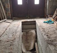 Unfinished interior of a family house with main entrance door and staircase.