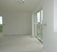 The interior of a family house with large windows and a spacious room.
